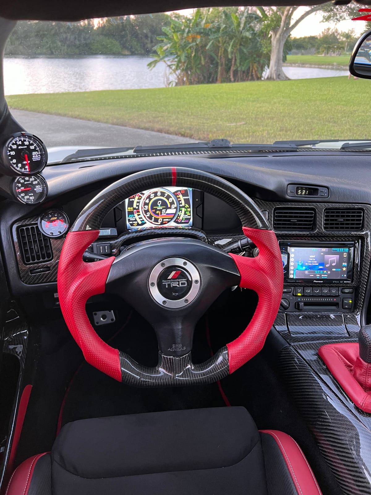Custom TRD steering wheel in red leather and carbon fiber inside a Toyota MR2 cockpit at Velocity Factor
