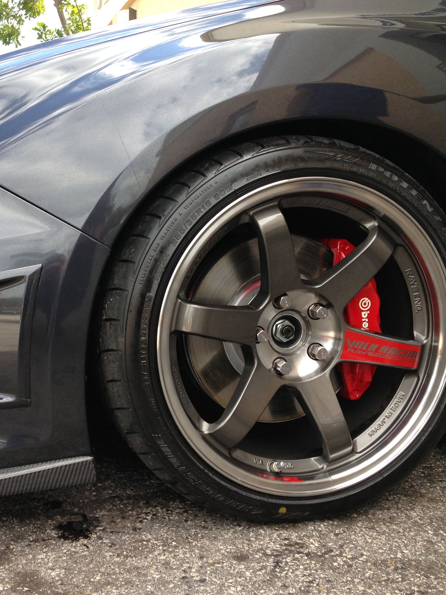 Volk Racing TE37 wheel over a red Brembo caliper on a gray Subaru WRX STI at Velocity Factor