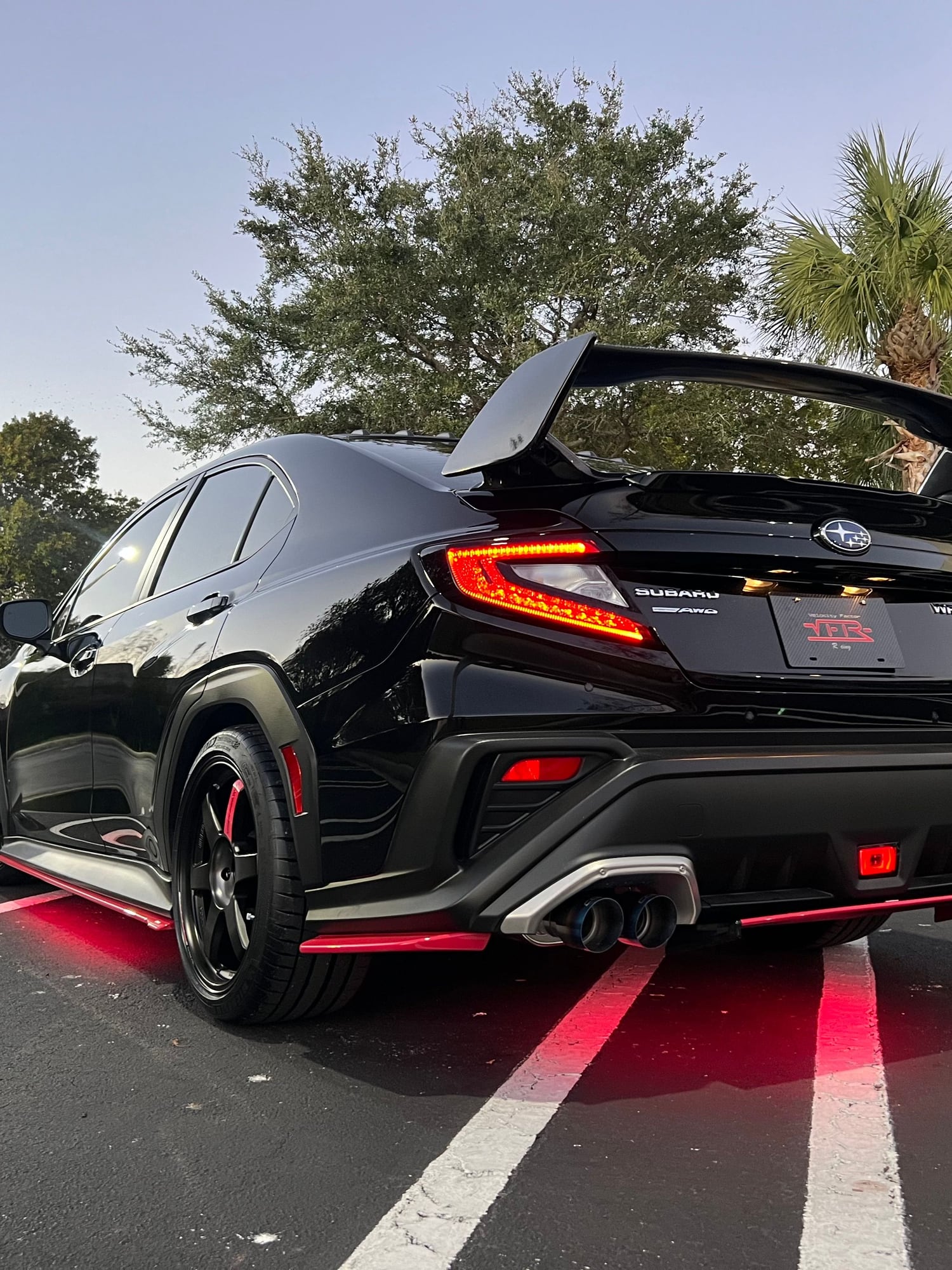 Black 2022+ Subaru WRX VB with rear wing and red accents photographed at dusk by Velocity Factor
