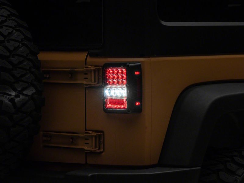 Raxiom 07-18 Jeep Wrangler JK Axial Series Lux LED Tail Lights- Black Housing (Clear Lens)
