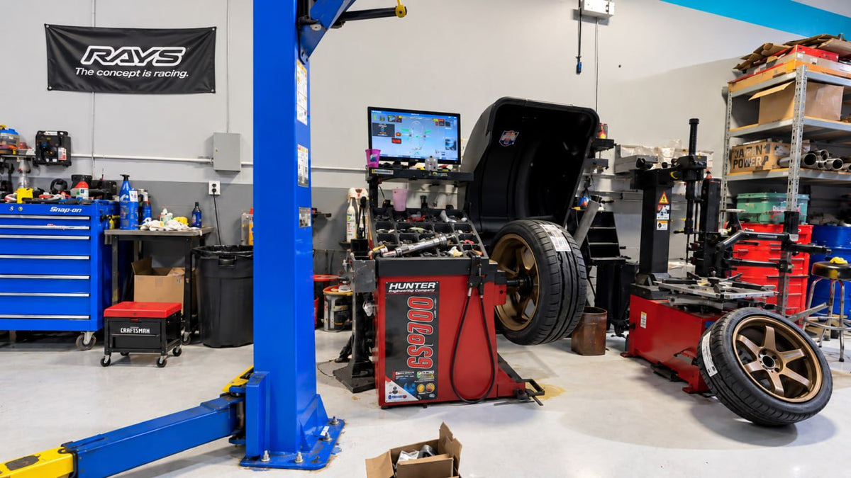 Velocity Factor tire bay in Coral Springs with a Hunter Road Force balancer, tire machine and bronze wheels under a RAYS banner