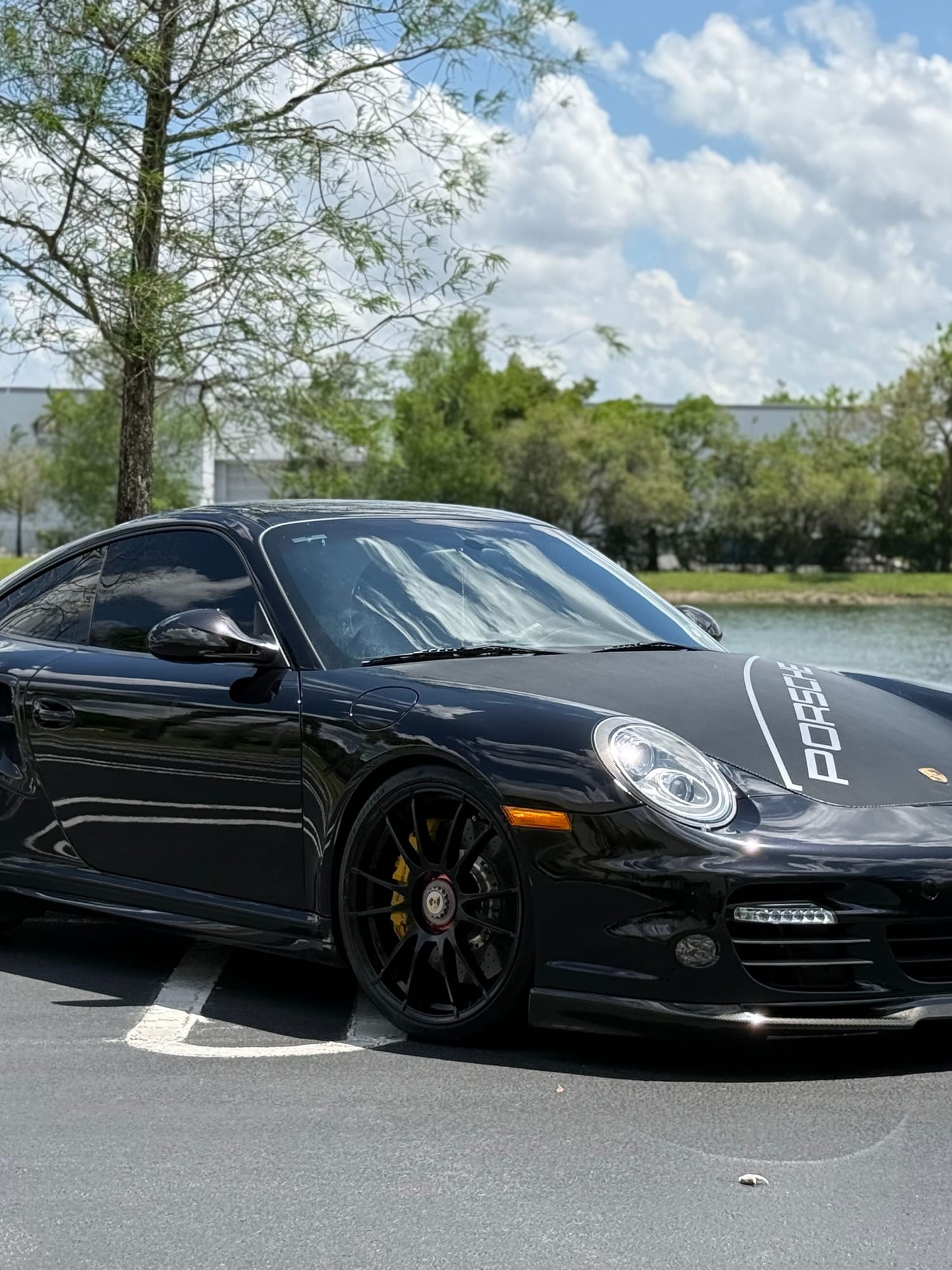 Black Porsche 911 Turbo (997) photographed lakeside at Velocity Factor