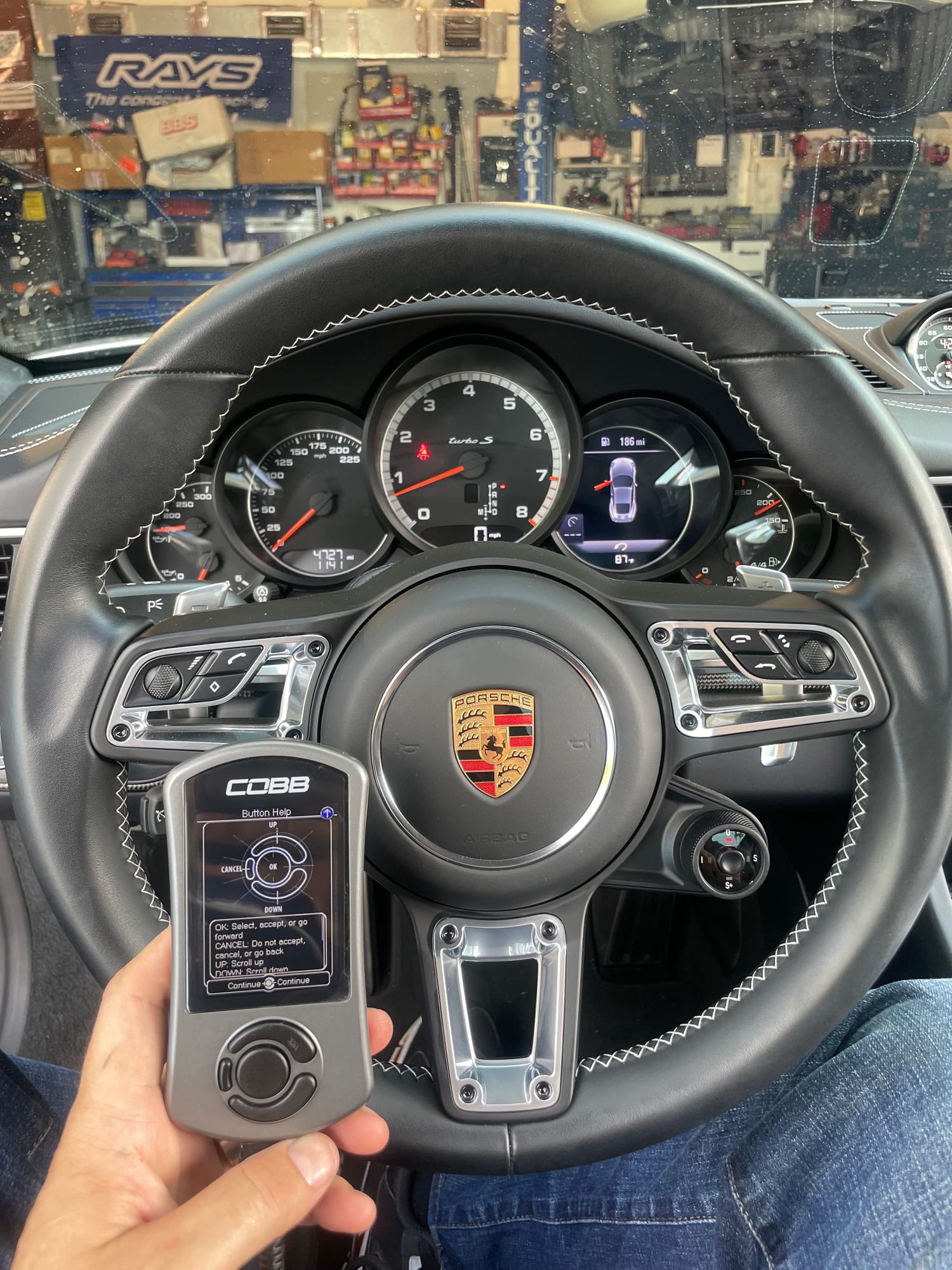 Porsche 911 steering wheel and COBB Accessport in a customer car at Velocity Factor