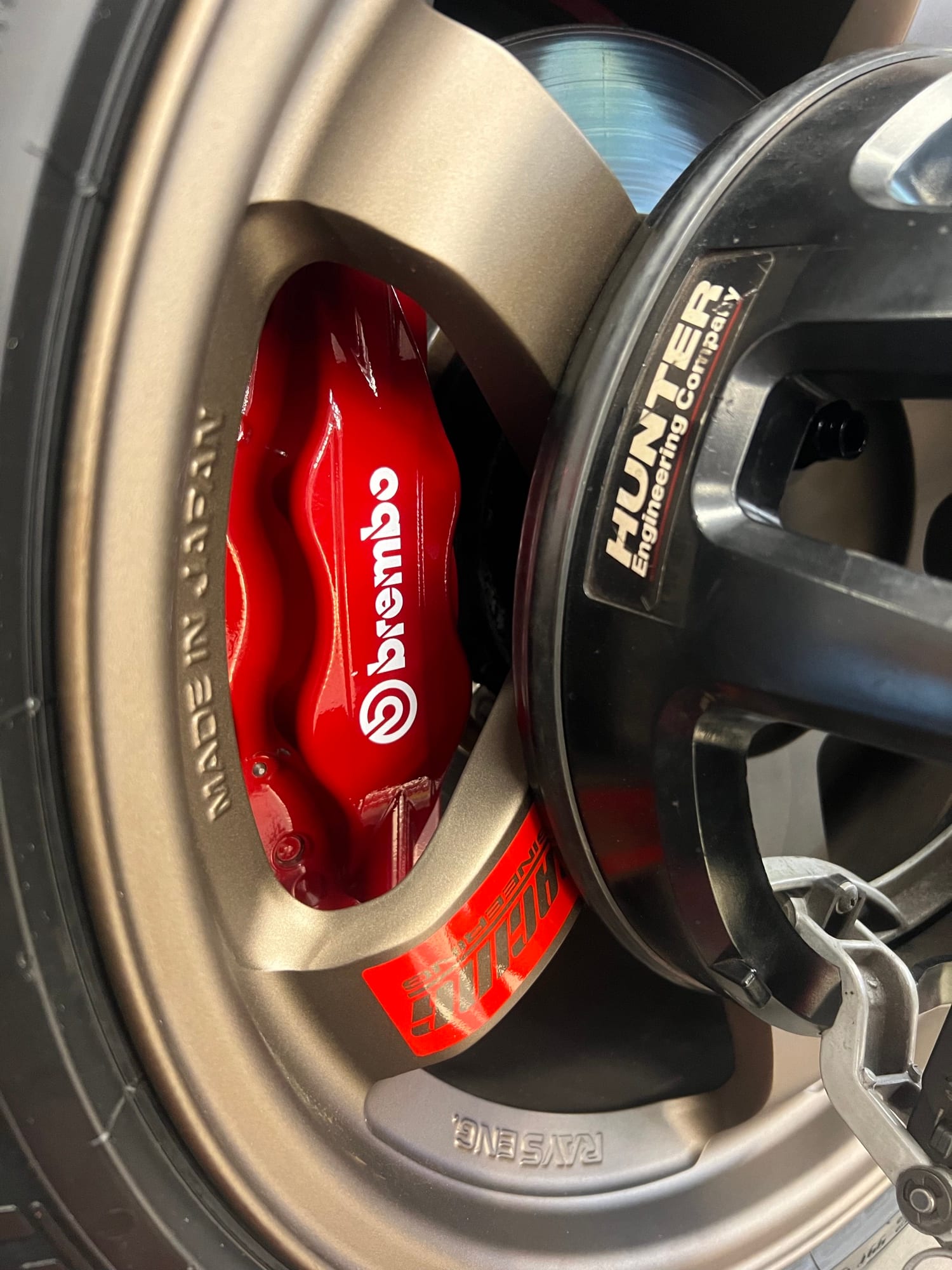 Red Brembo caliper behind a bronze RAYS wheel on the Hunter balancer at Velocity Factor