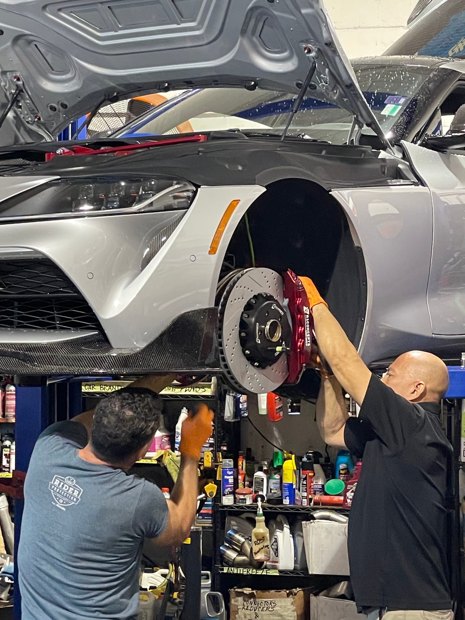 Velocity Factor technicians installing a big brake kit on a Toyota GR Supra MK5 on the lift