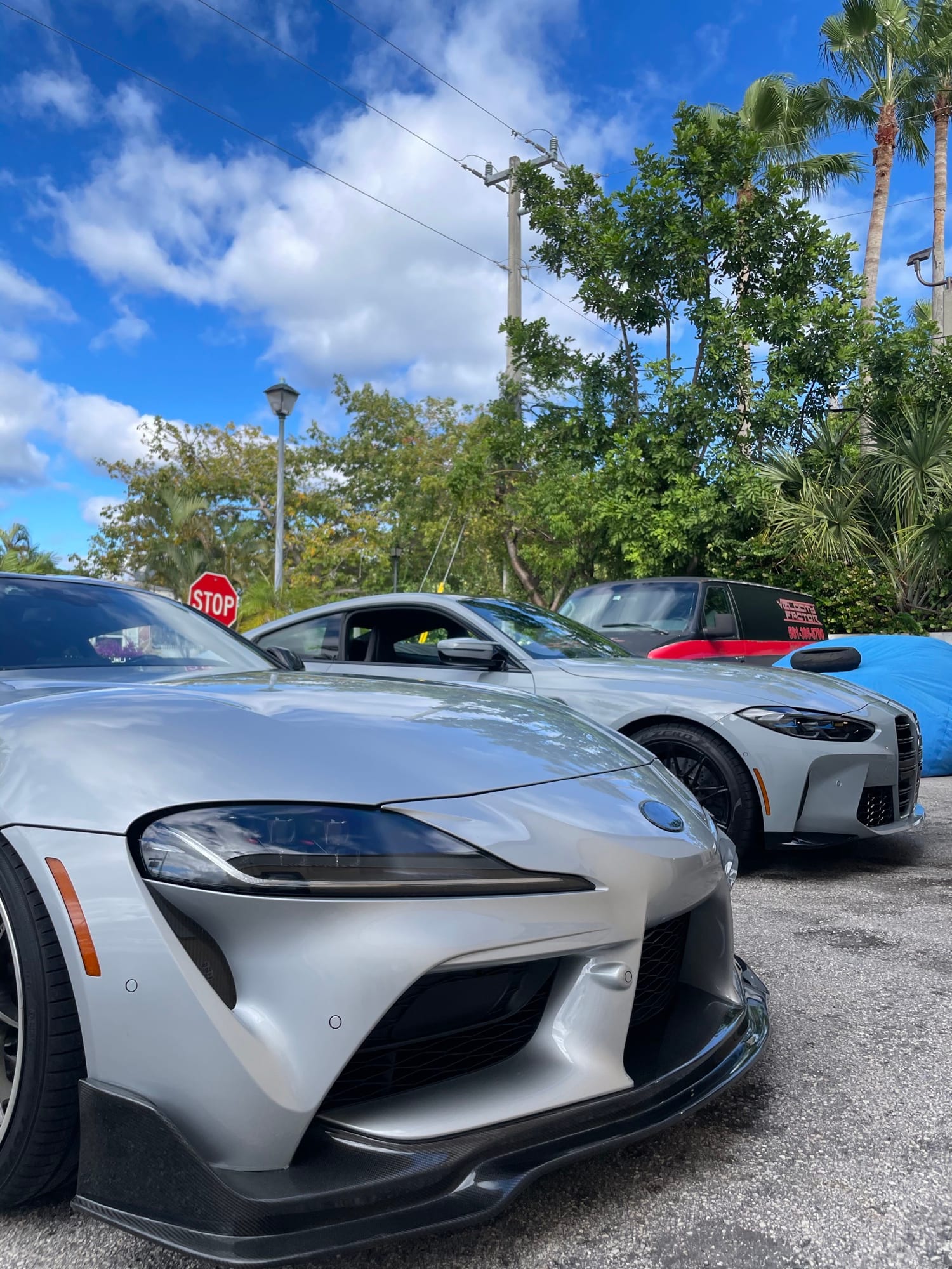 Toyota GR Supra MK5 with carbon front splitter parked beside a BMW G82 M4 at Velocity Factor