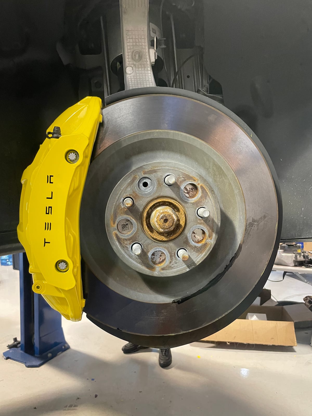 Tesla brake caliper color-changed to yellow on the lift at Velocity Factor