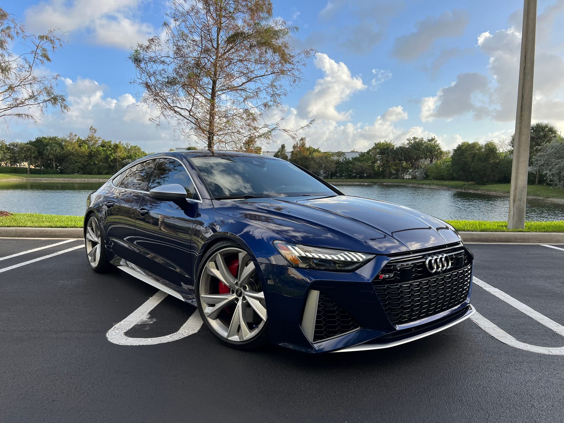 Navarra Blue Audi RS6 Avant (C8) photographed lakeside by Velocity Factor in Coral Springs