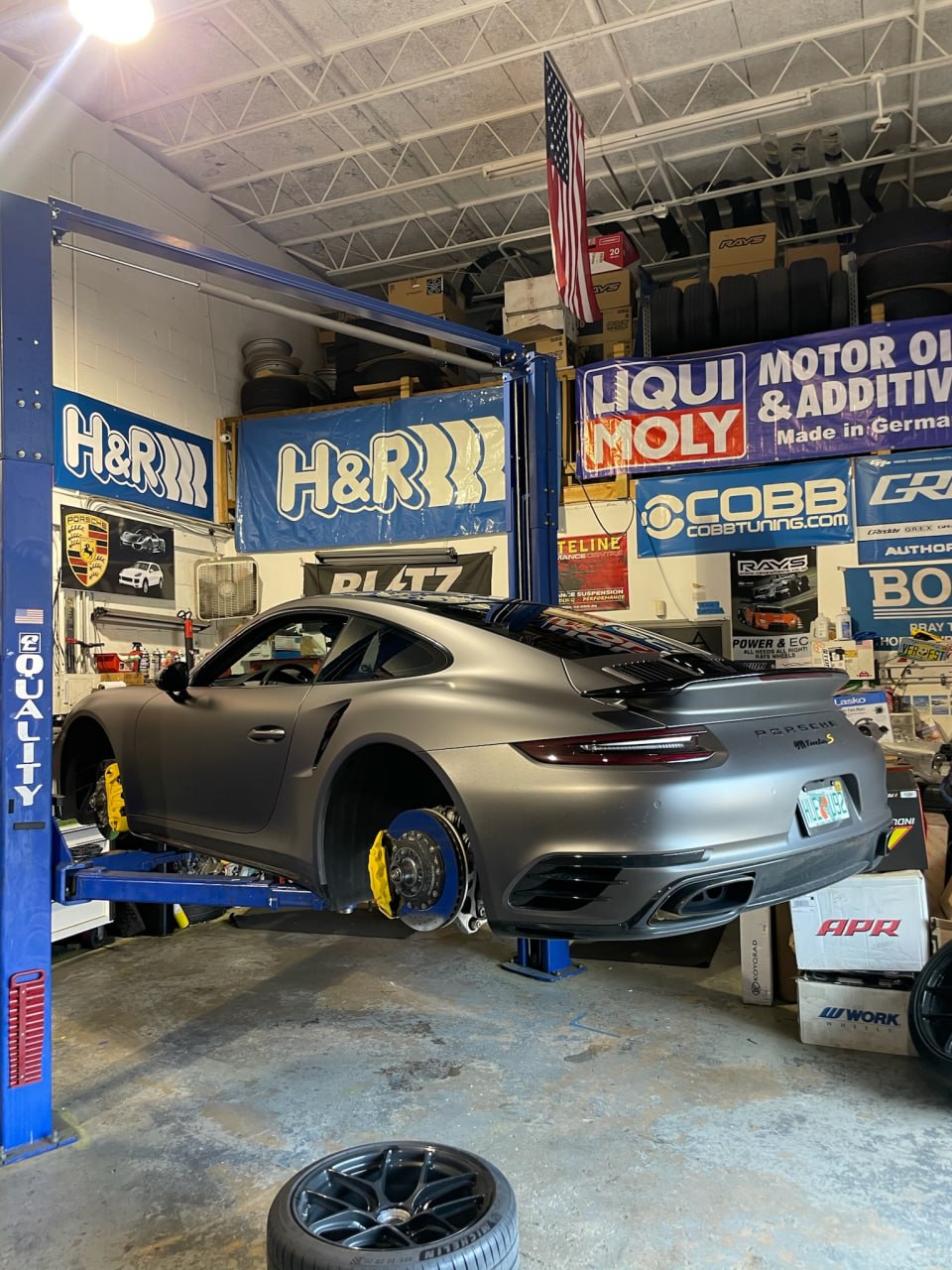 Porsche 911 Turbo on the lift during brake and wheel service at Velocity Factor