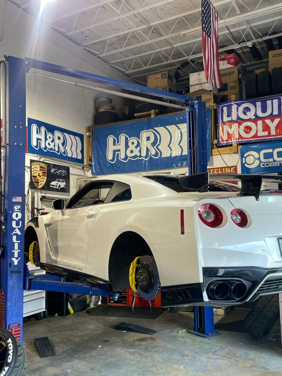 Nissan GT-R with yellow calipers on the lift for performance work at Velocity Factor