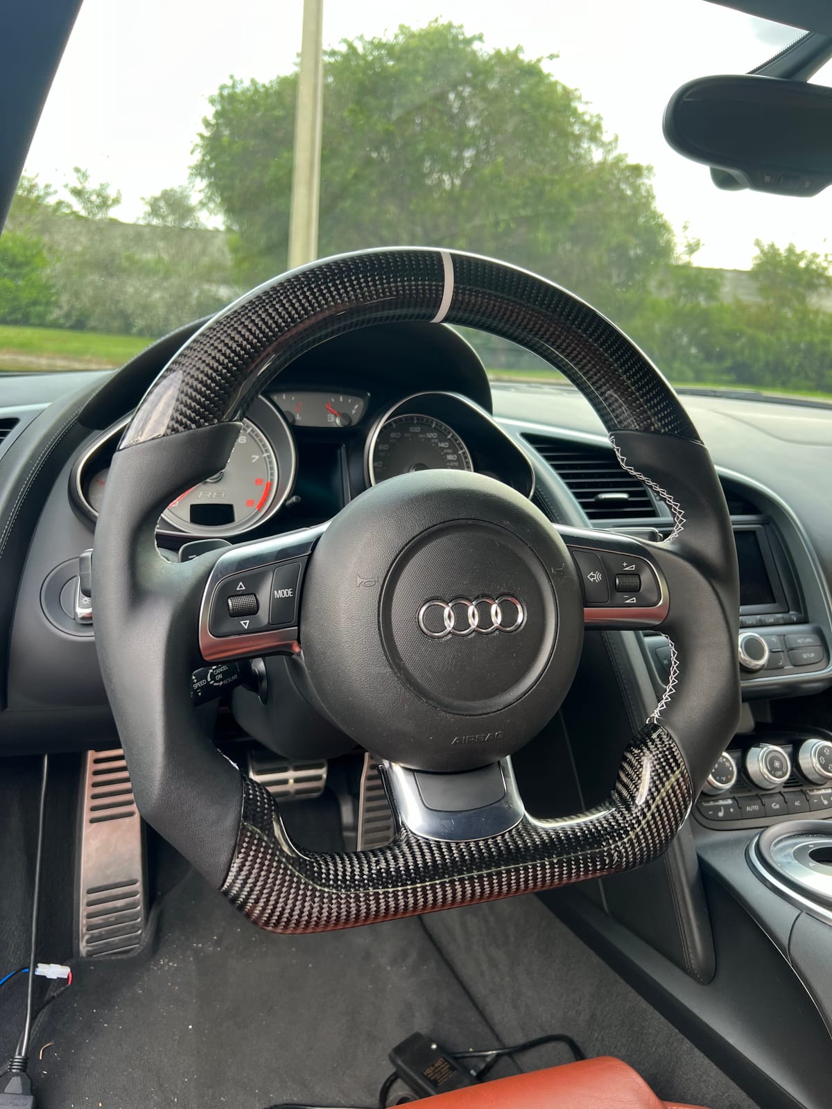Audi R8 custom carbon-fiber steering wheel with white centering stripe installed at Velocity Factor