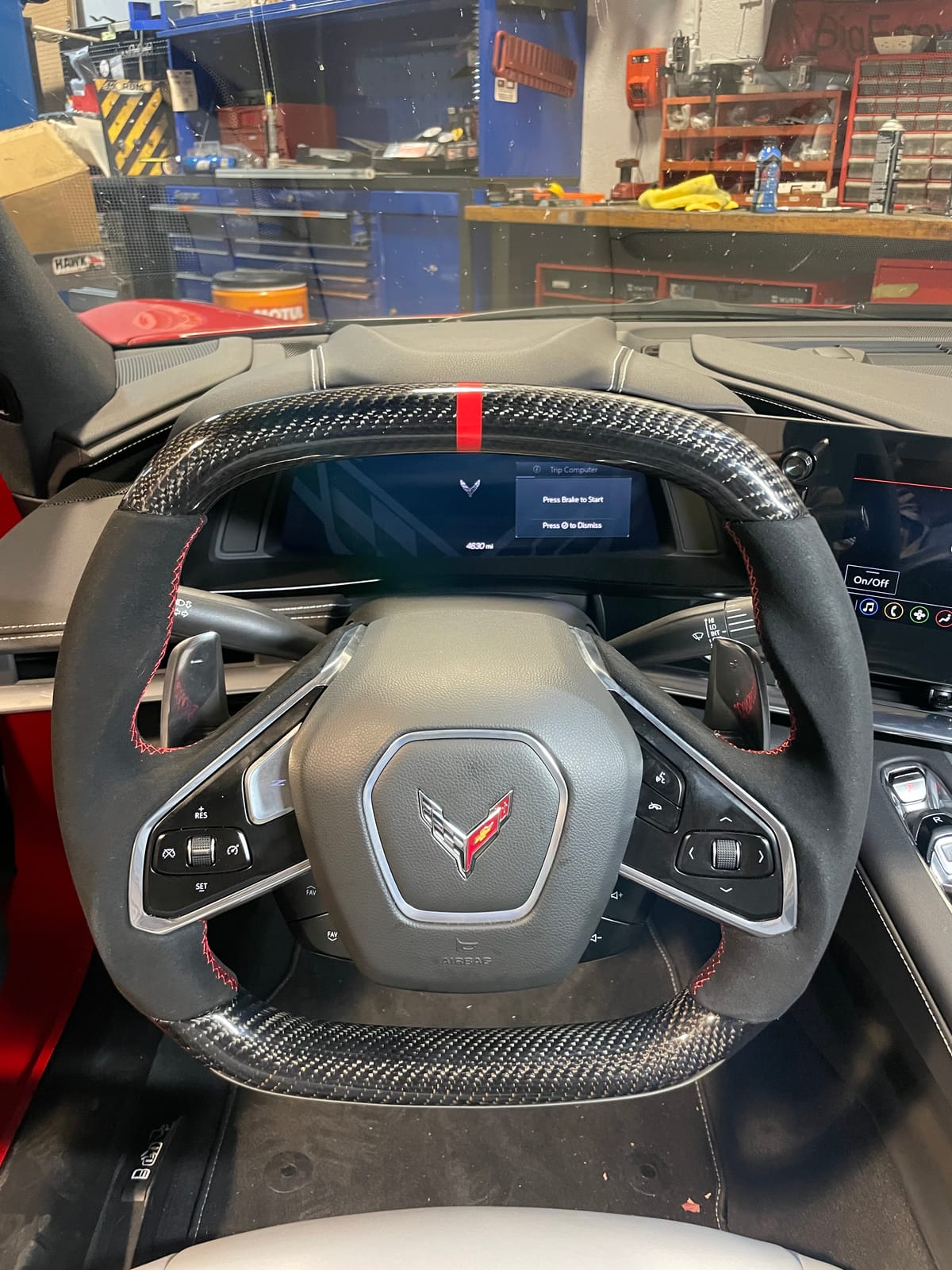 Corvette C8 steering wheel retrimmed in Alcantara and carbon fiber with red cross-stitching at Velocity Factor