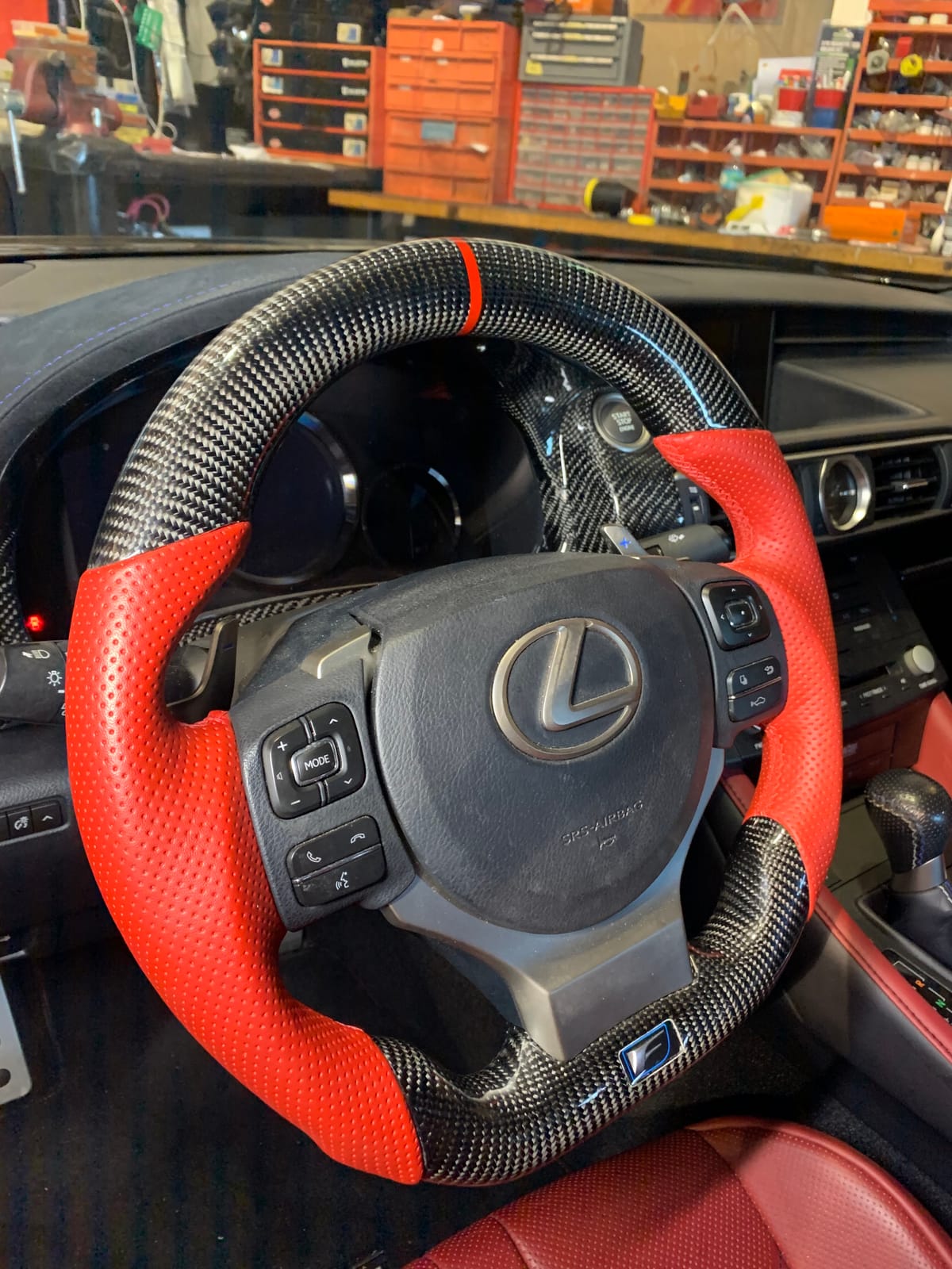 Lexus RC F custom carbon-fiber steering wheel with red perforated leather grips installed at Velocity Factor