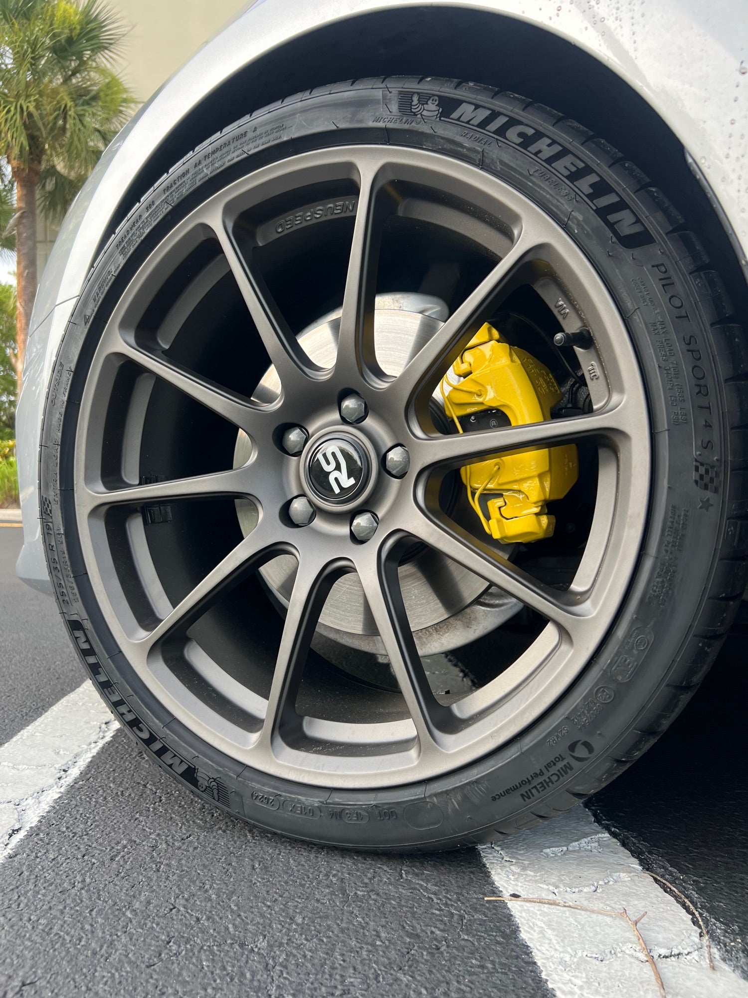 Gunmetal Neuspeed RSe wheel with yellow calipers and Michelin Pilot Sport 4S mounted at Velocity Factor