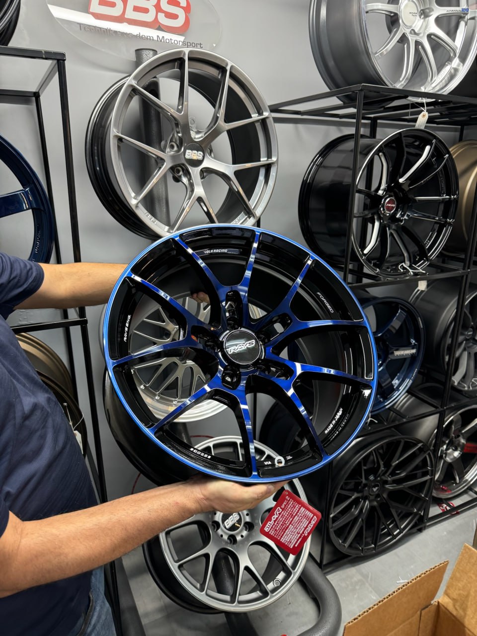 RAYS Volk Racing forged wheel in black with a blue machined face in the Velocity Factor showroom